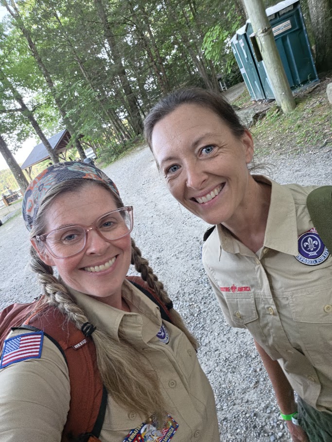Two Troop 444 leaders outdoors in Scouting uniforms.